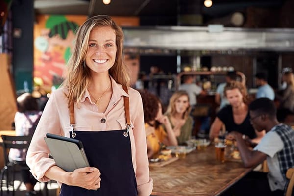 A restaurant manager with PowerEPOS on her tablet